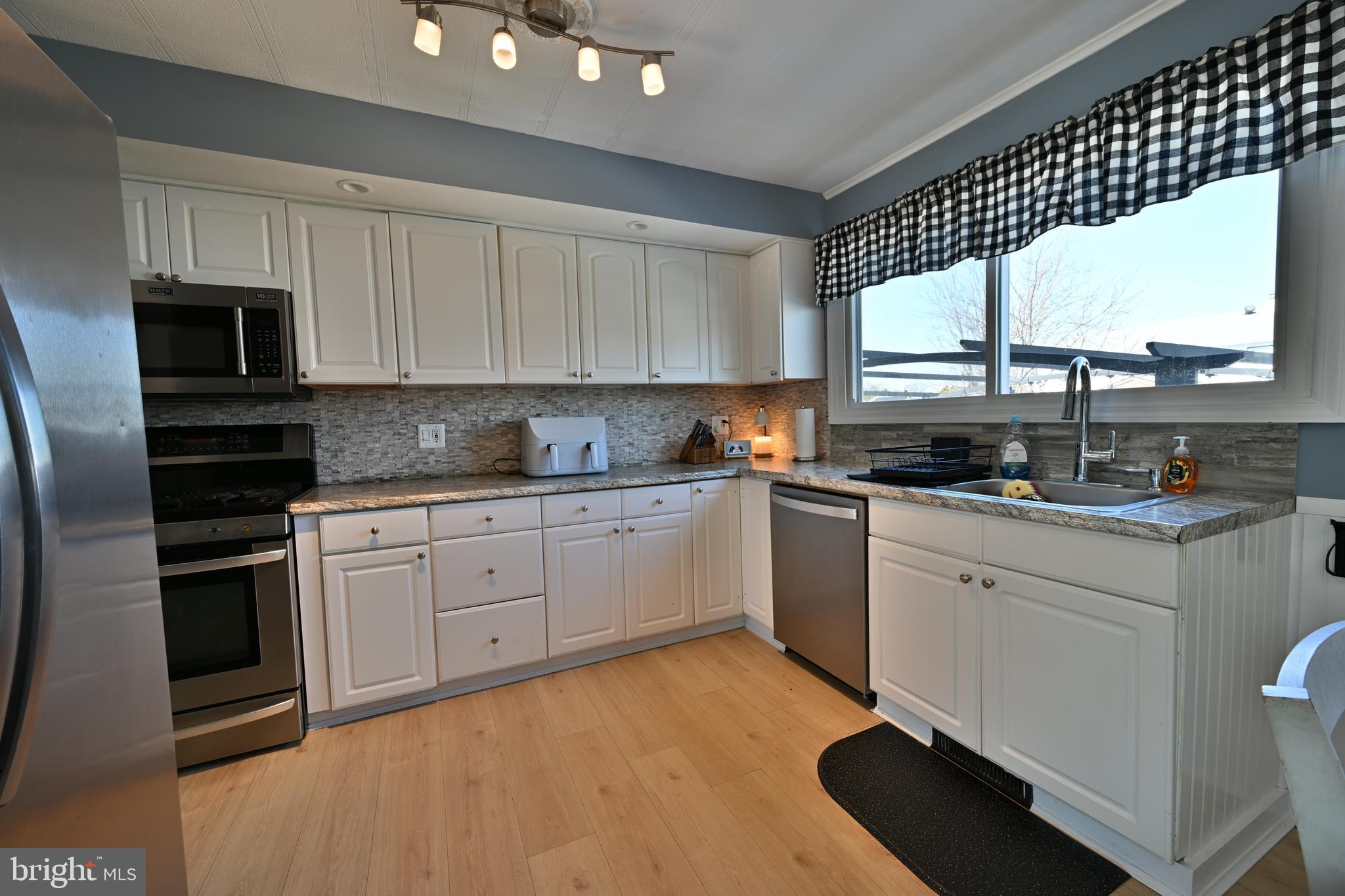 323 Mill Road Burlington, NJ 08016 - Photo 5 of 15 a kitchen with a stove a sink and a microwave