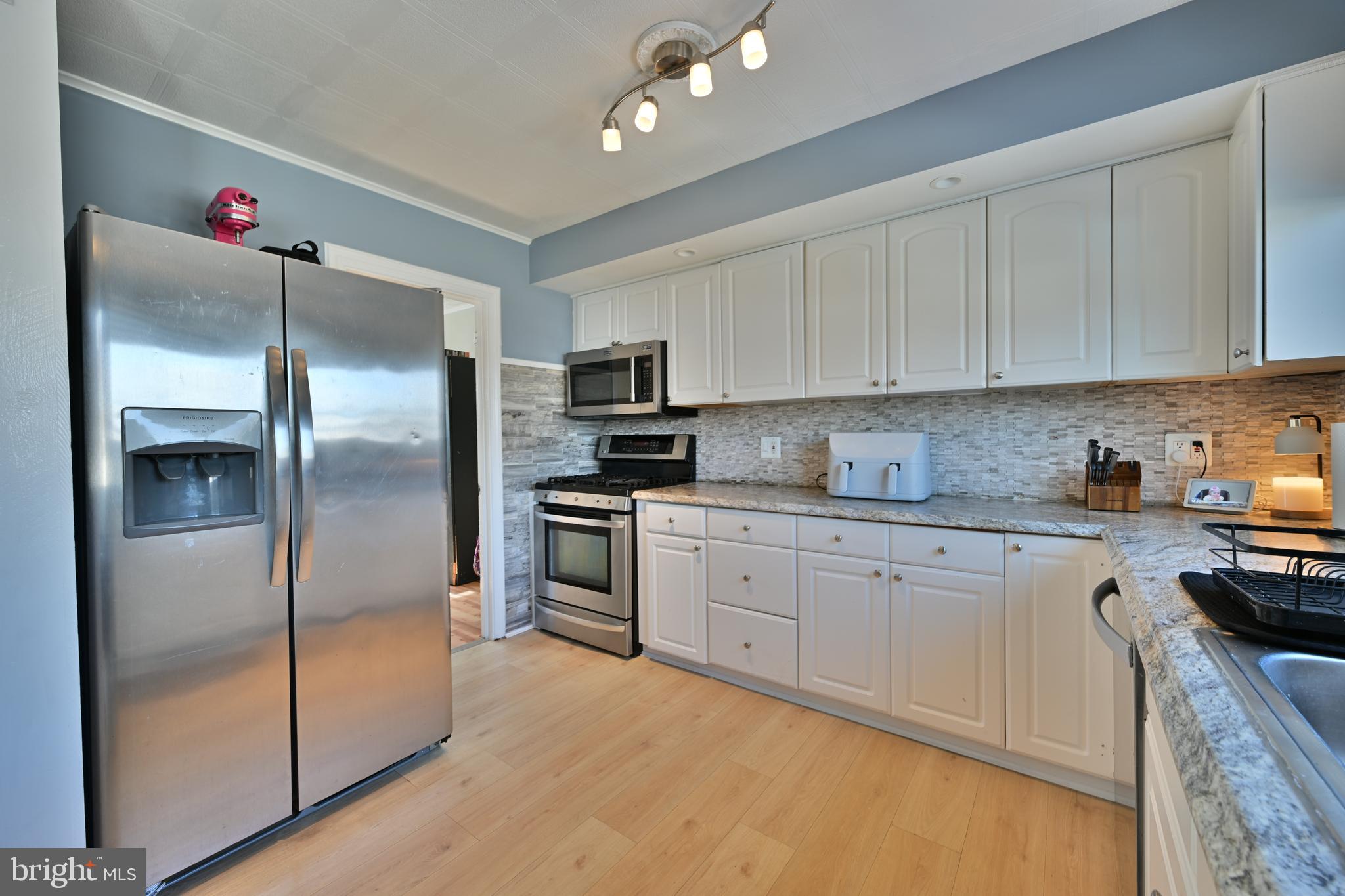 323 Mill Road Burlington, NJ 08016 - Photo 6 of 15 a kitchen with granite countertop a refrigerator sink and cabinets