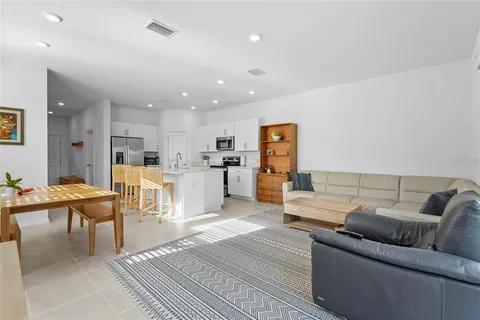 a living room with furniture and kitchen view