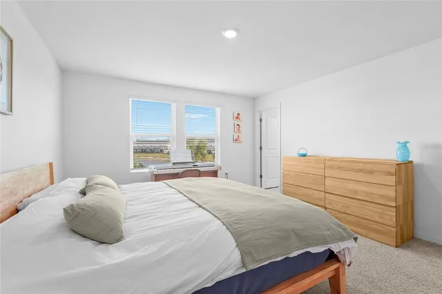 a bedroom with a bed and window