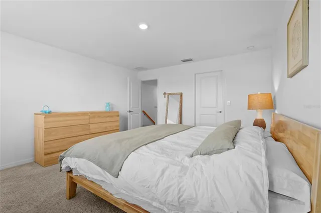 a bedroom with a bed and a lamp