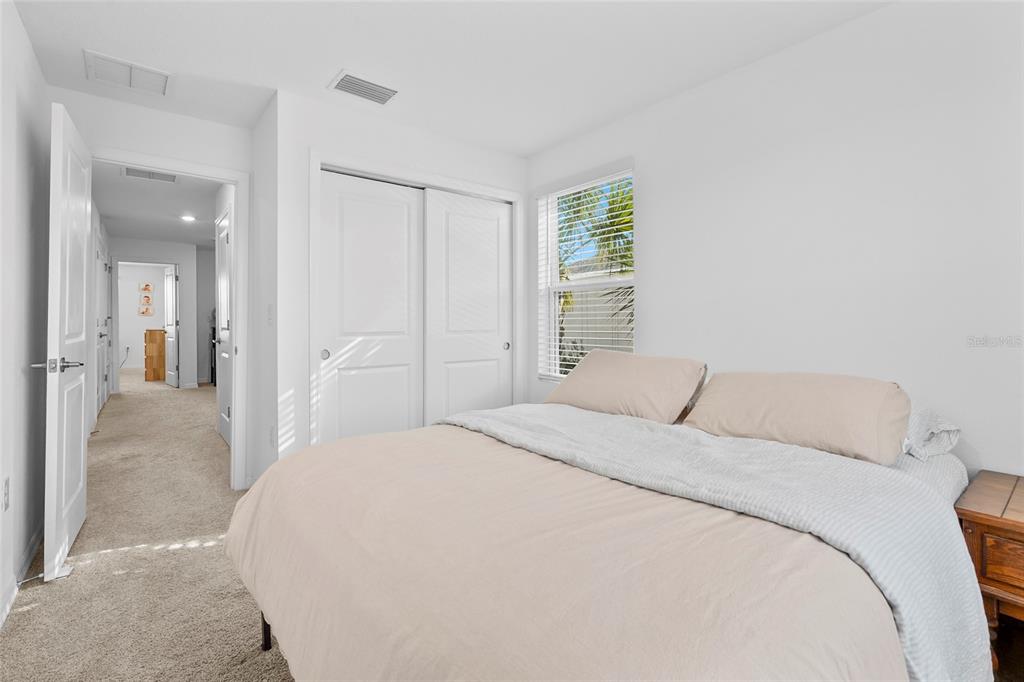 8564 Lunar Skye Street Sarasota, FL 34241 - Photo 25 of 44 a bedroom with a bed and a window