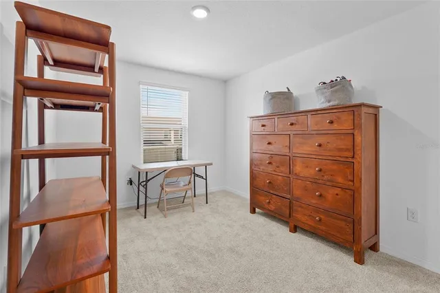 a room with a dresser and a chair