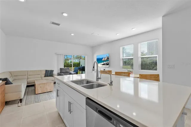 a large white kitchen with a large window