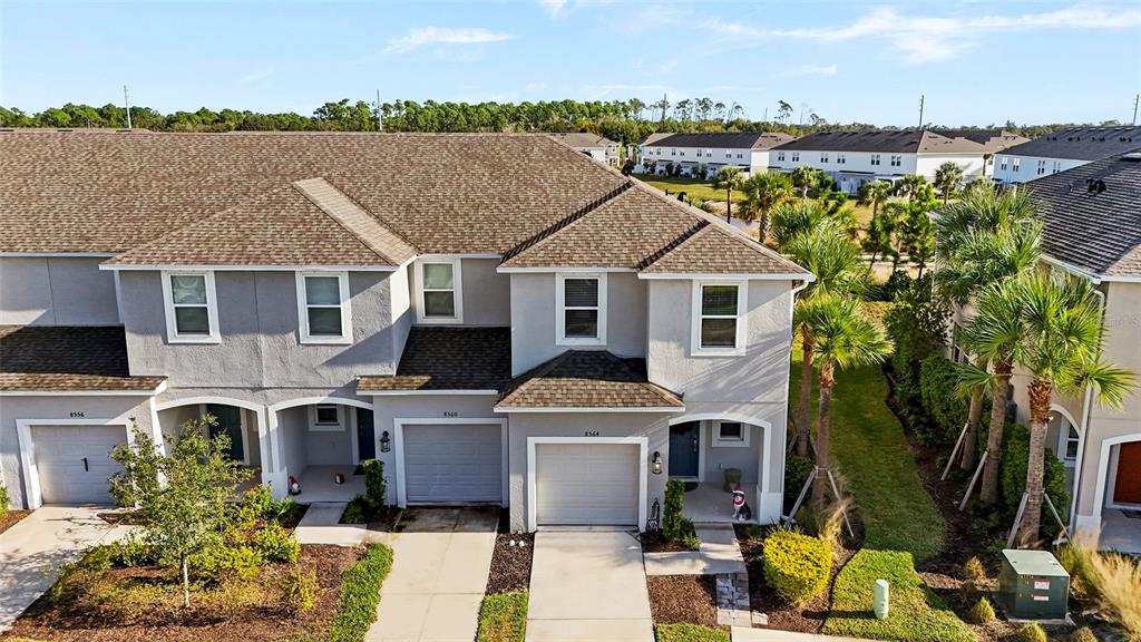 8564 Lunar Skye Street Sarasota, FL 34241 - Photo 42 of 44 an aerial view of a house with a garden and balcony