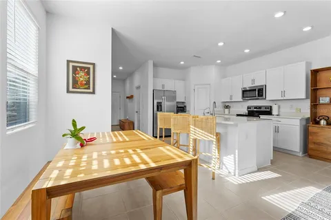 a kitchen with stainless steel appliances kitchen island granite countertop a refrigerator and microwave