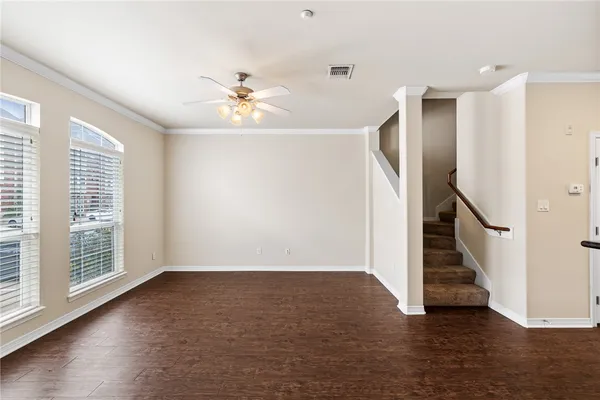 a view of an entryway with wooden floor and a ceiling fan