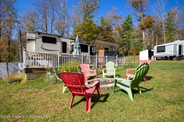 a living room with stainless steel appliances granite countertop furniture and a window