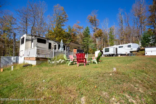 a bedroom with a bed and a dresser next to a window