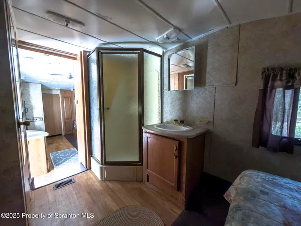 a bathroom with a toilet and a mirror