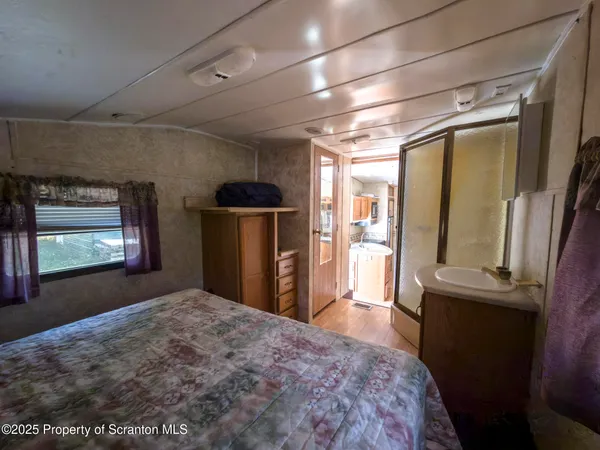 a bed sitting in a bedroom next to a window