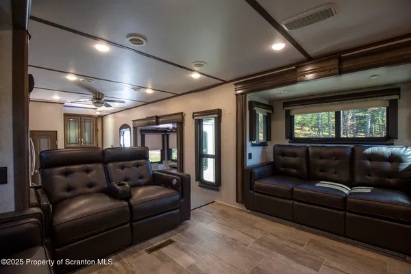 a living room with furniture fireplace and a large window