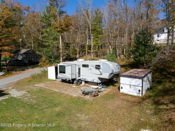 a view of a chairs and fire pit in the backyard
