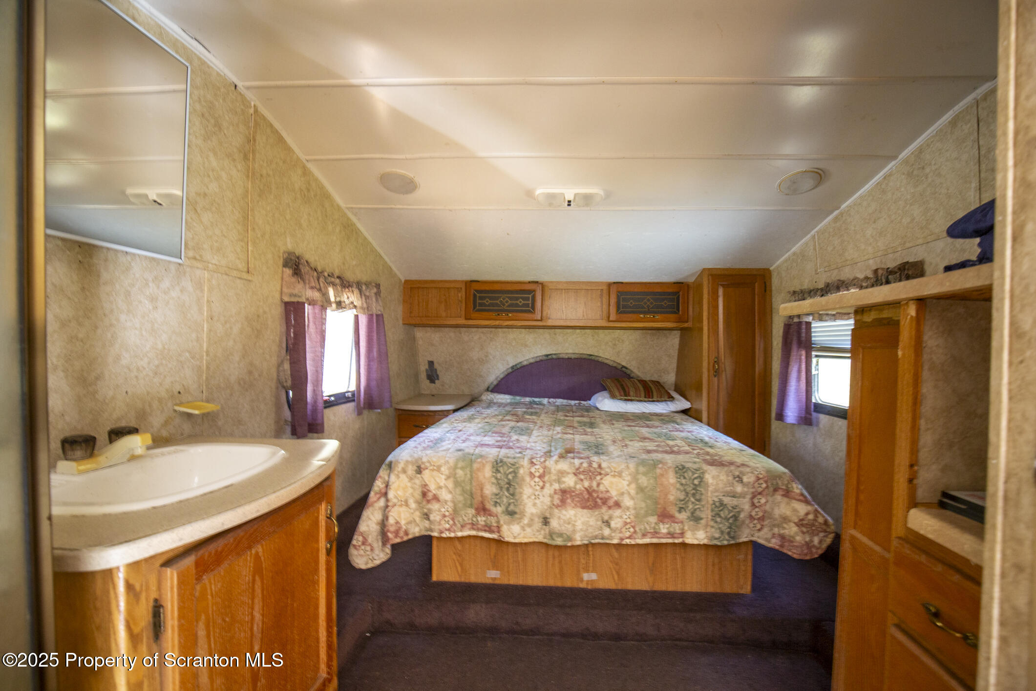 0 Lacawac Road Lake Ariel, PA 18436 - Photo 55 of 66 a bed room with a bed and a mirror