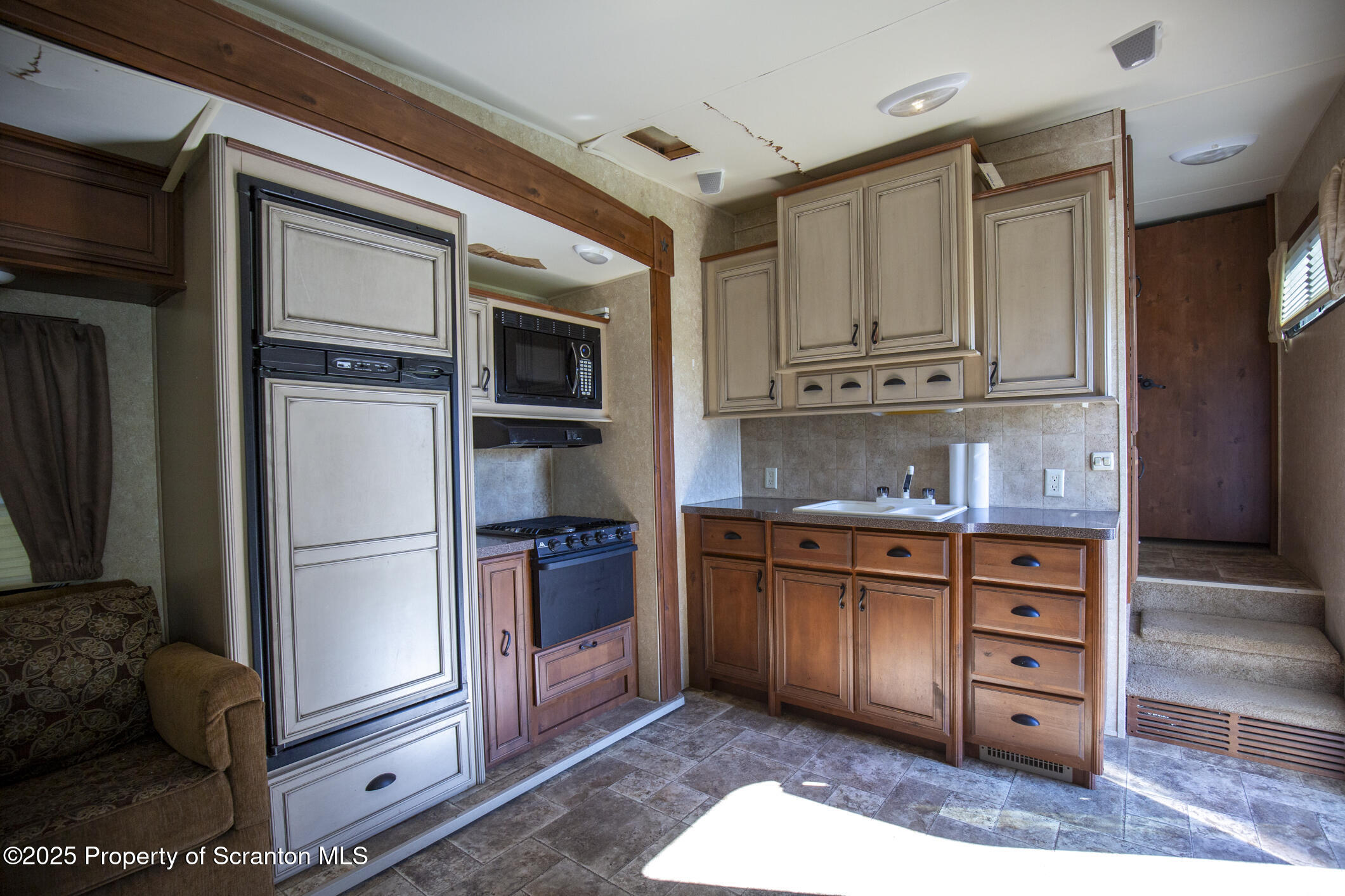 0 Lacawac Road Lake Ariel, PA 18436 - Photo 62 of 66 a kitchen with stainless steel appliances granite countertop a refrigerator and a stove top oven