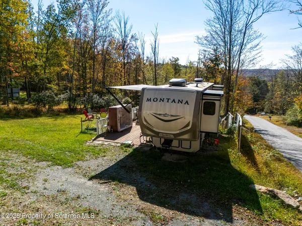 a view of a house with a yard and sitting area