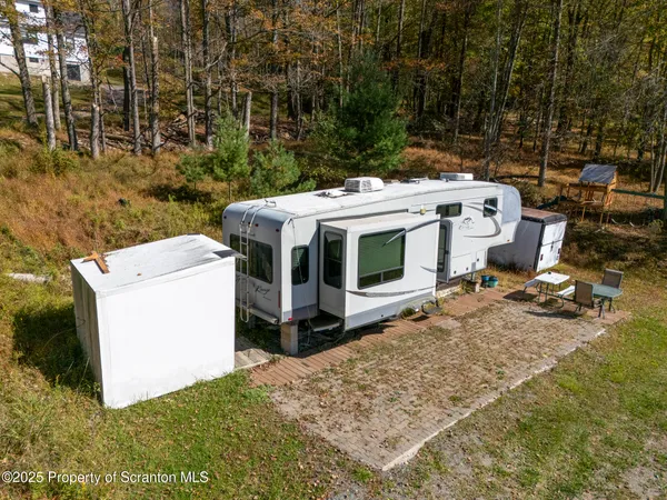 a aerial view of a house with a yard basket ball court and outdoor seating