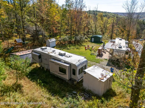 a view of a chair and table in backyard of the house