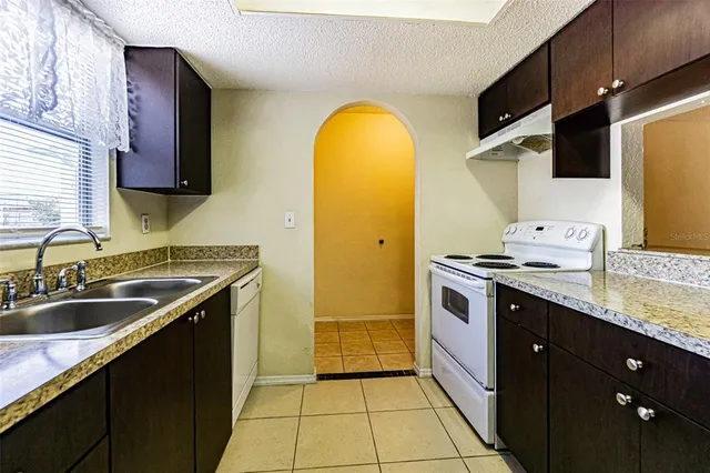 a kitchen with a sink stove and refrigerator