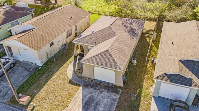an aerial view of a house with a yard
