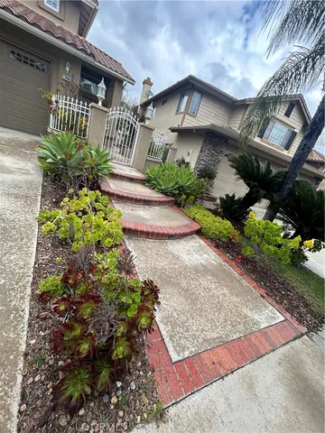a front view of a house with a yard and flowers