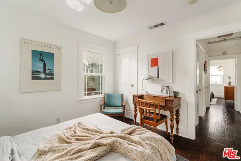 a bedroom that has a bed and a table in it