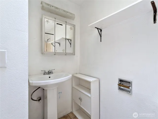 a bathroom with a sink mirror and vanity