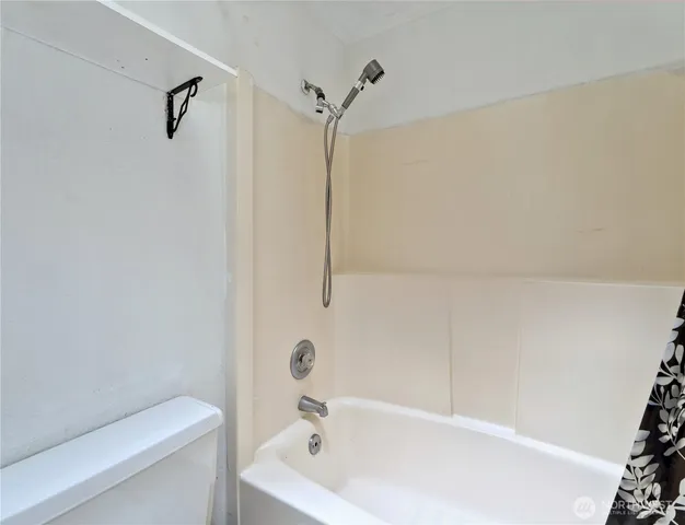 a bathroom with a bathtub and shower