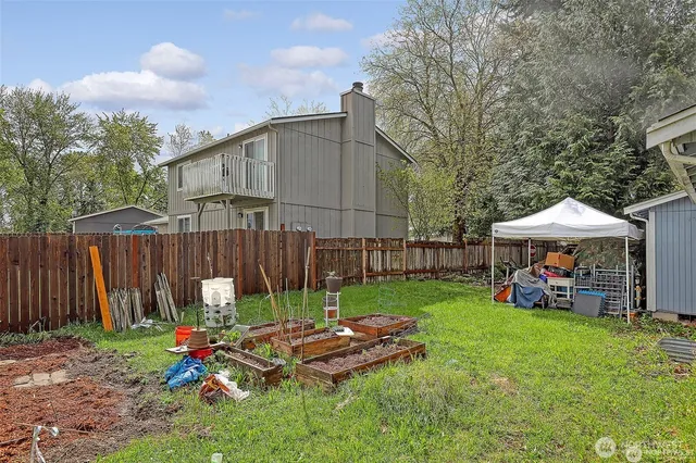a view of a chair and table in backyard