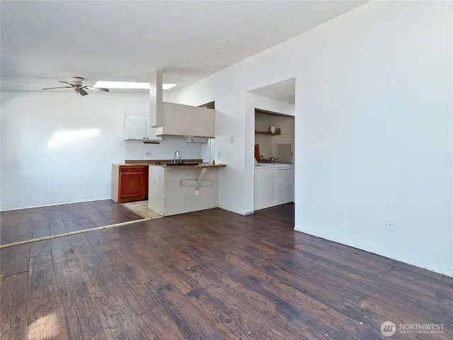 a view of kitchen with wooden floor and electronic appliances