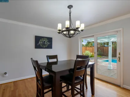 a view of a dining room with a table and chairs