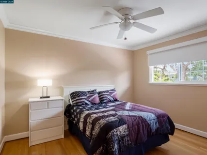 a bedroom with a bed and a ceiling fan