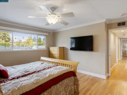 a bedroom with a large bed and a flat screen tv