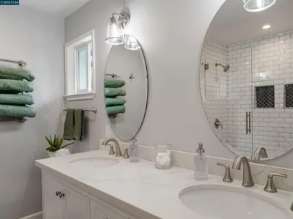 a bathroom with double vanity sinks and a mirror