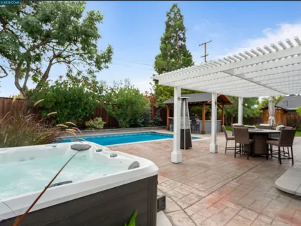 a view of a patio with table and chairs and potted plants
