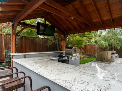 a view of backyard with furniture and barbeque grill