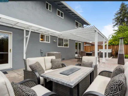 a view of a patio with couches chairs and a table and chairs