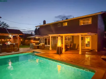 a view of a patio with swimming pool table and chairs