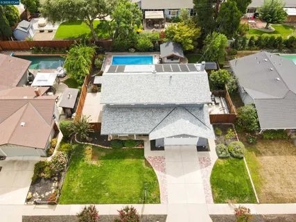 an aerial view of residential houses with outdoor space