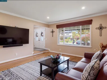 a living room with furniture and a flat screen tv