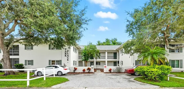 a group of cars parked in front of a house