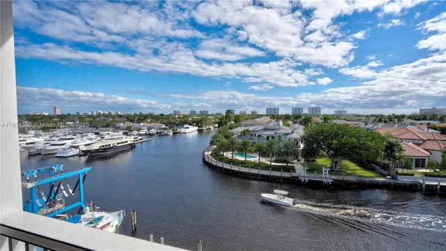 an aerial view of a residential houses with outdoor space and ocean view