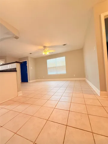 a view of a livingroom with an empty space and a window