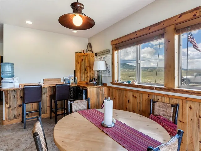 a dining room with furniture a chandelier and wooden floor