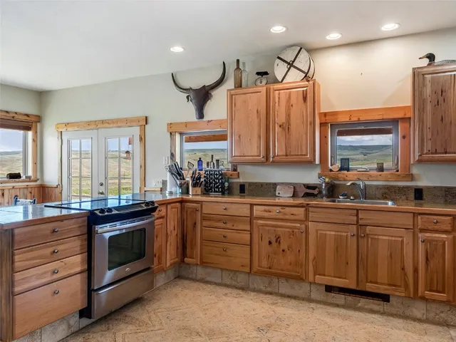 a kitchen with a sink and a stove top oven