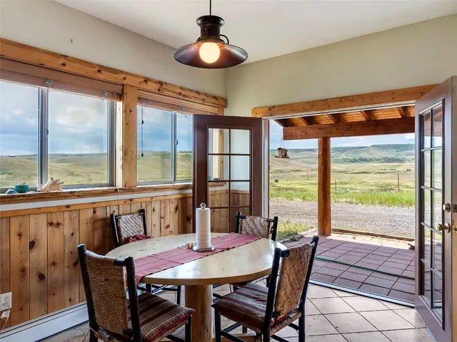 a view of a dining room with furniture large windows and wooden floor