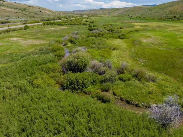 a view of a field with an ocean