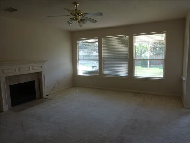 a view of empty room with a fireplace