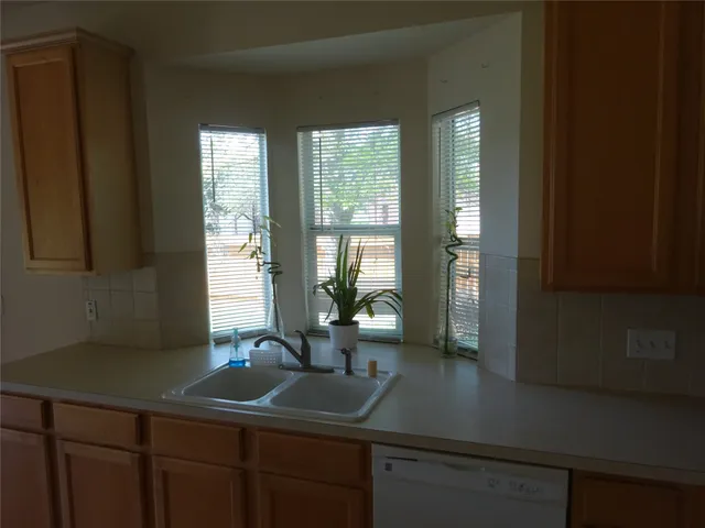a kitchen with a sink and a window