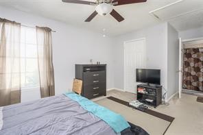 10763 Sandpiper Drive Houston, TX 77096 - Photo 20 of 26 a bedroom with a bed and a flat screen tv